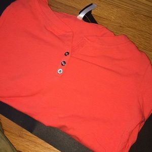 This is and orange/peach colored long sleeve shirt